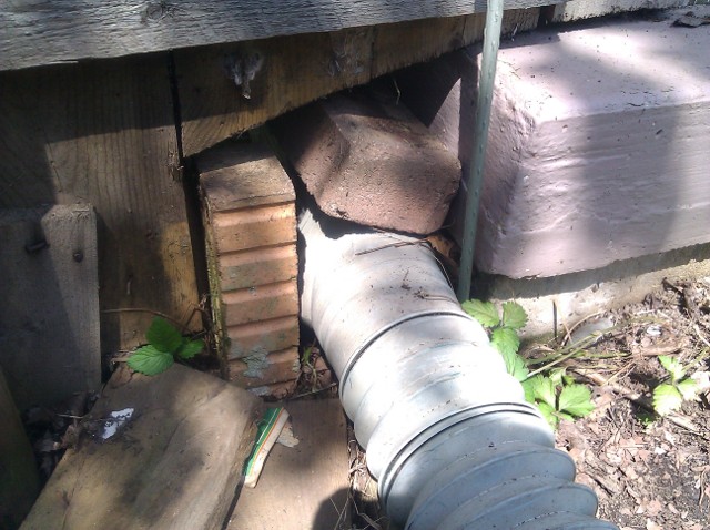 Downspout opening with bricks